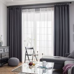 a living room filled with furniture and curtains