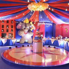 a circus themed birthday party with balloons and decorations on the dancefloored floor