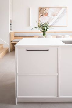 a white kitchen with an island and sink