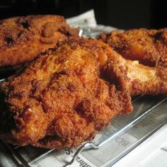 three fried food items sitting on top of a plastic tray