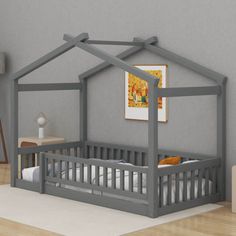 a baby's room with a gray bed frame and white sheets on the floor