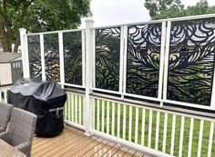 an outdoor deck with grill and chairs on it, next to a large screen door