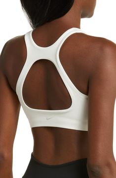 Get into your groove in this ultracomfy sports bra with signature Dri-FIT tech and a breezy back cutout to keep you cool and dry. Racerback Dri-FIT moisture-wicking technology Lined 80% polyester, 20% elastane Machine wash, line dry Imported White Nylon Activewear With Built-in Padding, White Micro-elastic Sports Bra For Gym, White Nylon Sports Bra For Running, Nike Nylon Activewear, Functional Nike Nylon Activewear, Nike Functional Nylon Activewear, Athleisure Nylon Sports Bra For Sports Events, Nylon Activewear With Built-in Bra For Sports, Versatile White Activewear With Light Support