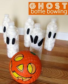 a halloween decoration made out of toilet paper and plastic balls on the floor with text overlay that reads, pumpkin bottle bowling