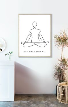 a white wall with a black line drawing of a person sitting in a yoga pose