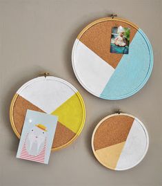 three circular wall hangings with pictures on them