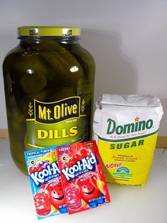 pickles, yogurt and other ingredients are on the counter next to a jar