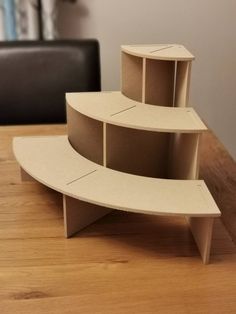 three shelves sitting on top of a wooden table