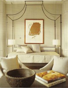 a bedroom with a canopy bed and white walls