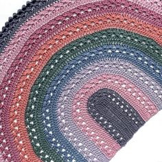 a crocheted rug with an oval design on the top and bottom in various colors