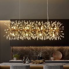 a modern chandelier hanging over a dining room table