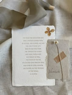 a piece of paper with a poem on it next to a ribbon and some other items