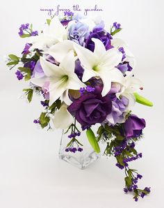 a vase filled with purple and white flowers