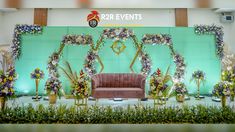 the stage is decorated with flowers and greenery