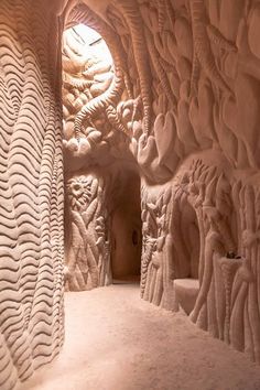 the interior of an ice cave with wavy patterns on it's walls and floor