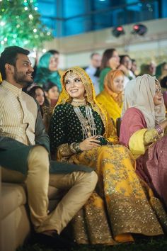 two people sitting next to each other at a wedding