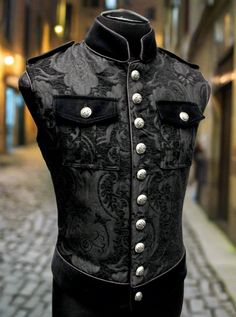 Note: This vest is very fitted. Check the measurements for each size below carefully before you order.A vintage style military vest from the old country. Late 19th-century officer's vest in gorgeous black tapestry fabric. Trimmed with contrast black velvet collar, waistband and pocket flaps. Fastens in front and on pockets with metal medieval lion buttons. There are two large inside breast pockets - one on each side. Edged all over with black satin piping. Lined inside with rich black satin. Com Black Tapestry, Military Vest, Velvet Collar, Royal Marines, Tapestry Fabric, Mens Vests, Vests Mens, New Man, Black Satin