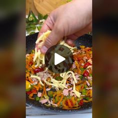 someone is adding cheese to some food in a skillet