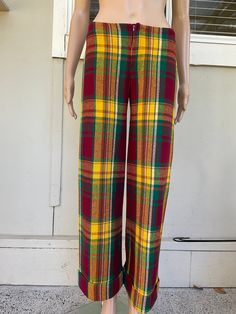 These vintage 70s Bay City Rollers-inspired bell bottom dress pants are a statement piece for any hipster wardrobe. Made from high-quality wool, the red and yellow check pattern adds a pop of colour to any outfit. With large turn ups they so remind me of the late 70s and a pair I used to wear - all the time! These dress pants are a size XS and are perfect on my size 8 mannequin. Fastening with a short zipper. for those who love a mix of vintage and city style. The pants feature a regular fit and Retro Multicolor Fall Pants, 70s Inspired Wide Leg Pants For Fall, 70s Inspired Fall Pants, 70s Inspired Full-length Pants For Fall, 70s Inspired Full-length Fall Pants, Retro Flare Pants For Fall, Retro Flare Bottoms For Fall, Retro Fitted Wide Leg Pants For Fall, 70s Inspired Full Length Bottoms For Fall