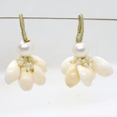 two pairs of earrings with pearls on them