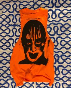 Leigh Bowery...what more can I say.  Screen Printed on a "Hazard Orange" Gildan Brand T-Shirt with Black Water Based Fabric Ink. Marked with the Jeff Chiola logo on the back. Additional sizes are available upon request.  *This item is hand printed each shirt is made to order making each piece unique.   Sizes XL and above are extra $2.00. First the first wash: Inside out and in cold water.  The ink will become softer with wear & wash. Funny Print Cotton Top In Alternative Style, Alternative Cotton Tops With Funny Print, Alternative Cotton Top With Funny Print, Unisex Screen Print Tops For Alternative Fashion, Funny Print Cotton T-shirt For Alternative Fashion, Alternative Cotton T-shirt With Funny Print, Orange Graphic Design Tops For Summer, Orange Graphic Design Top For Summer, Pre-shrunk Punk Summer Tops