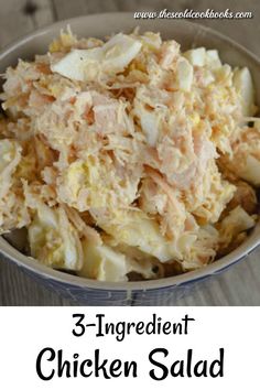 a bowl filled with chicken salad on top of a wooden table