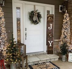 front porch decorated with christmas trees and wreaths