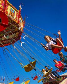 people are riding on a carnival ride