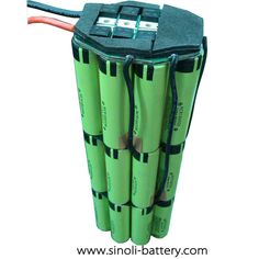 four batteries are stacked on top of each other with wires attached to the battery cover