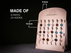 a wooden board with many different key chains hanging from it's sides and measurements