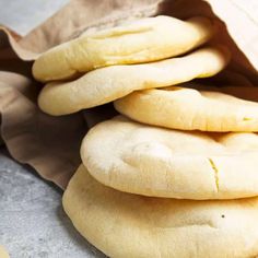 a pile of uncooked bread sitting on top of a table