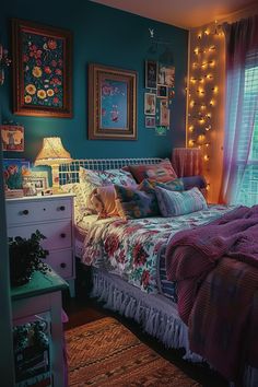 a bedroom with blue walls and pictures on the wall above the bed is decorated with lights