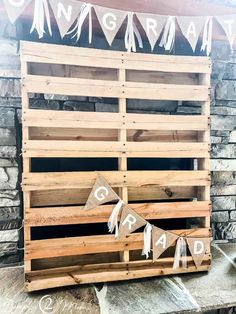 a wooden crate sitting on top of a stone floor next to a sign that says congratulations