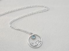 Mountain Silver Necklace | Special Occasion Jewelry | Mountain Minimal Jewelry | Necklace With Topaz | Delicate Necklace | Jewelry For Women Metal: Silver 925 Stone: Natural Topaz of 0.1ct diameter 3 mm Necklace length: 45 cm Impressive necklace decorated with a pendant with a mountain motif. The mountain massif enclosed in a circular setting was made with great care, so that the decoration faithfully reflects the picturesqueness of the mountain landscape. Thanks to this, not only the outline of the ridge, but also the drawing of gullies, the texture of rocks and small spruce trees at the foot of the mountain are clearly visible. To emphasize the detail of the sculpture, the pendant was oxidized and polished. It is topped off with a hand-framed natural topaz of blue color, shimmering beaut Silver Topaz Necklaces With Birthstone, Silver Topaz Birthstone Necklaces, Silver Blue Topaz Pendant Necklace, Silver Necklaces With Blue Topaz Birthstone, Silver Topaz Necklace As Gift, Silver Topaz Pendant Necklace, Silver Topaz Necklaces For Anniversary, Silver Topaz Necklace Fine Jewelry, Silver Topaz Necklace For Anniversary