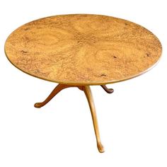 a round wooden table with two legs and a circular top, on a white background