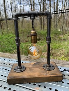 an old fashioned light bulb sitting on top of a metal table