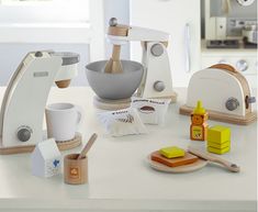 a kitchen scene with focus on the mixer and other items that are being used to make food