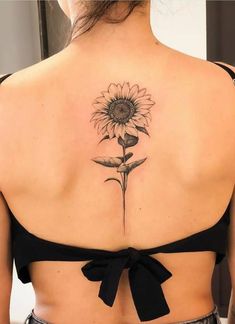 a woman with a sunflower tattoo on her back