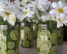 four mason jars filled with lemon slices and daisies are shown on the instagram page