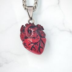 🖤 Embrace your dark elegance with my Handcrafted Realistic Heart Pendant Necklace 🖤 Indulge your Gothic sensibilities with this strikingly lifelike anatomical heart pendant, meticulously crafted by hand from rich, blood-red epoxy resin.  ✨ Product Details: * Material: Each pendant is carefully handcrafted from high-quality epoxy resin, capturing the essence of a real heart with its intricate details and deep, captivating color. * Chain: Paired with a durable stainless steel, braided style chai Anatomical Heart Pendant, Realistic Heart, Anatomical Heart Necklace, Real Heart, Resin Product, Dark Elegance, Anatomical Heart, Blood Red, Creepy Cute