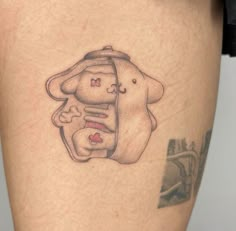 a woman's thigh with a tattoo on it that has an elephant holding a baby