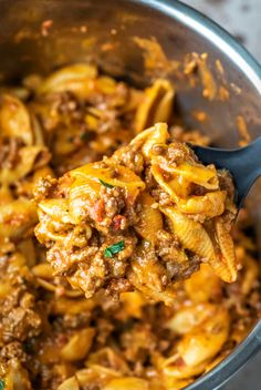 a spoon full of pasta with meat and cheese