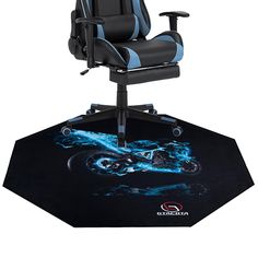 a black and blue gaming chair sitting on top of a desk with a mouse pad