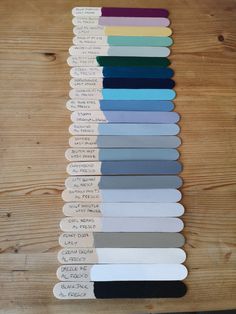 the different colors of paint swatches on a wooden table