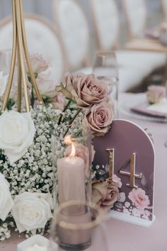 the table is set with flowers and candles