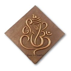 an intricately designed ganesha on a brown paper napkin with gold foiling