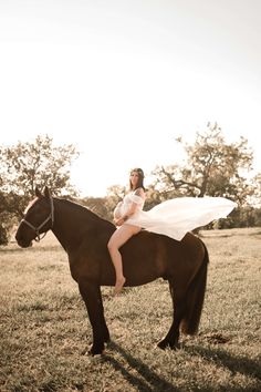 a woman is sitting on top of a horse