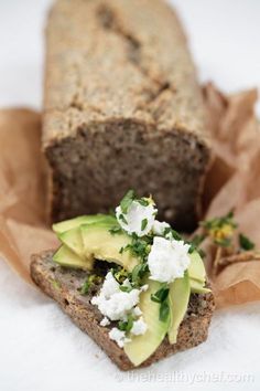 a loaf of bread with avocado and feta on top