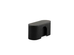 a small black object sitting on top of a white surface