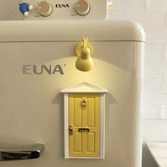 a white refrigerator with a yellow door and some knobs